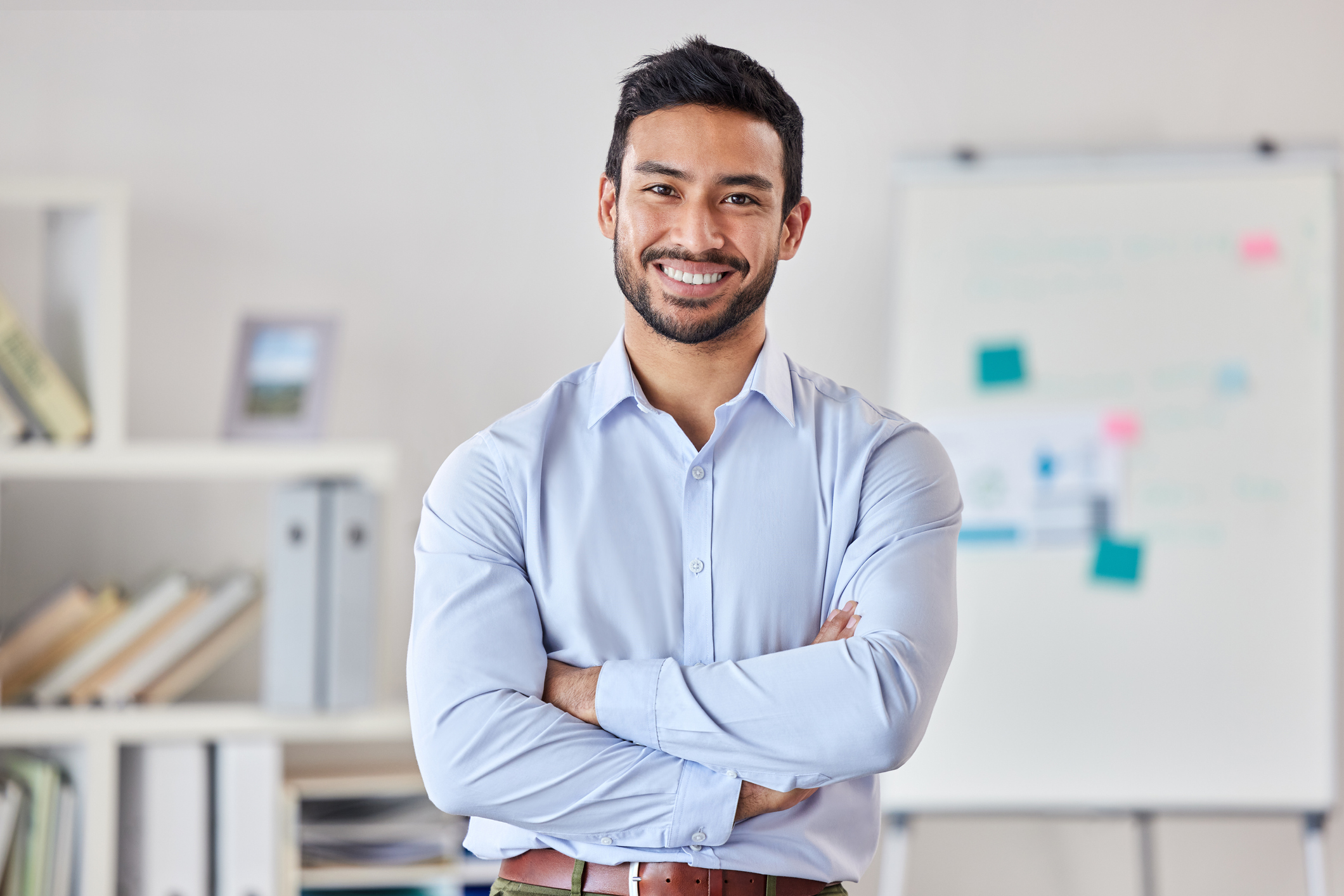 Professional woman in hijab standing confidently in an office